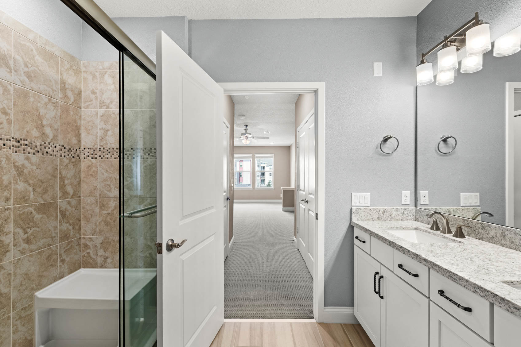 bathroom with open door and walk in shower